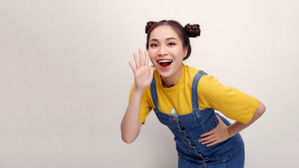 Excited shocked young woman 20s posing screaming with hands gesture near mouth looking camera isolated on white background