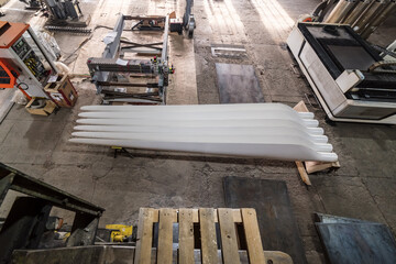 Wind turbine blades in the factory floor. View from above. Photo taken at an industrial plant in Russia