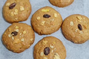 In selective focus a group of cookies in a tray on a baking paper