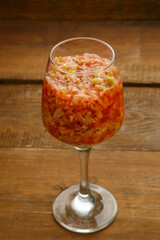 Glass of fresh kiwi apple smoothie on a wooden table.