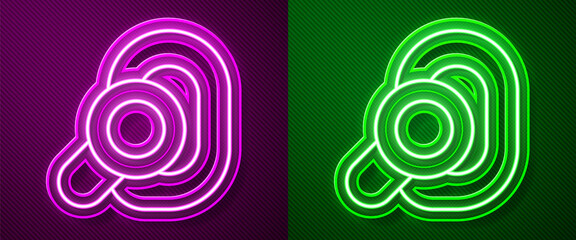 Glowing neon line Hearing aid icon isolated on purple and green background. Hearing and ear. Vector.