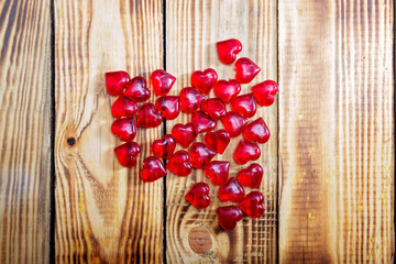 Red hearts on wooden background top view..