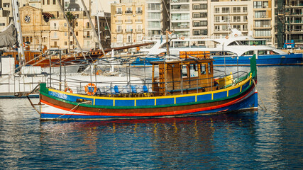 Fototapeta na wymiar Traditional Maltese boat in an old harbor