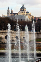 Bridge of Segovia across the Manzanares river, fountains and Santa Maria la Real de La Almudena Cathedral in Madrid, Spain