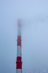 Bottom view of a smoking pipe in a haze of fog.