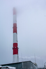 Bottom view of a smoking pipe in a haze of fog.