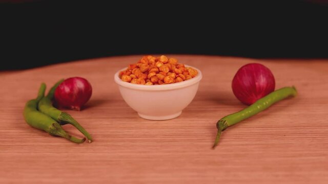 Yellow Chatpata dal, dhal, Indian snack,chana dal in white bowl on wooden table,pepper sev,mota sev,south indian snacks,Namkeen or Assorted Salty Snack on wooden spoon in white bowl,Namkeen, Farsan,