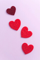Flatlay red hearts on a pink background. Concept of Valentine's day, wedding. Copy space.