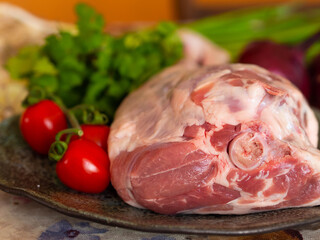 Fresh and raw meat. Leg of lamb on wood background