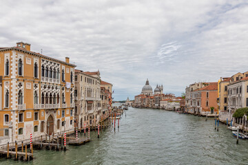 Fototapeta na wymiar The grand canal in Venice Italy looking towards Basilica di Santa Maria della Salute from Acadamia Bridge