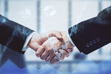 Double exposure of forex graph hologram and handshake of two men. Stock market concept.
