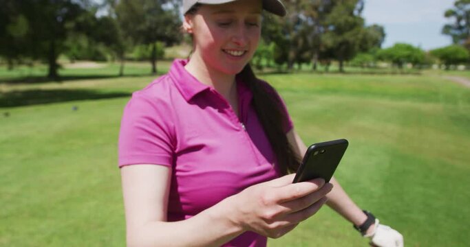 Caucasian woman playing golf using a smartphone