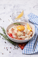 Classic carbonara pasta with fried bacon, parmesan cheese and egg yolk.