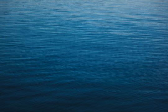 Smooth of beautiful blue sea water with fine ripples, surface and abstract natural background
