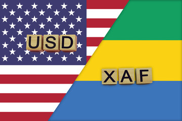 USA and Gabon currencies codes on national flags background