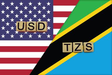 USA and Tanzania currencies codes on national flags background