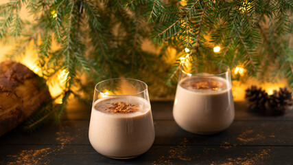 Traditional winter cocktail Eggnog with grated cinnamon. Christmas mood.