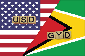 USA and Guyana currencies codes on national flags background