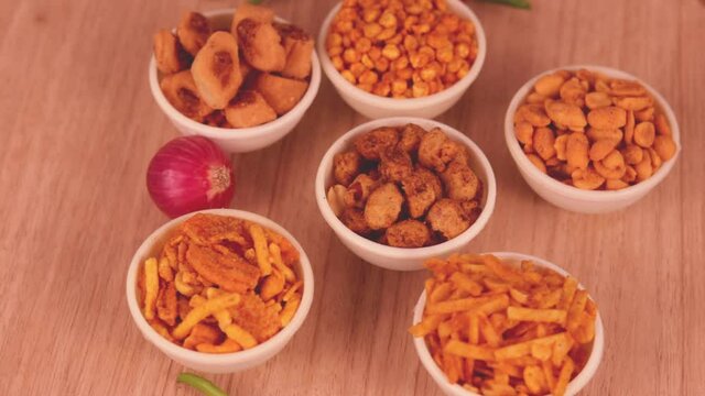 chivda indian snacks group of Indian Traditional Spicy And Sweet Namkeen Food,Namkeen, Farsan, with green chilli peppers on table