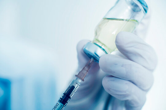 a nurse draws a vaccine into a syringe. close-up. vaccination concept covid-19