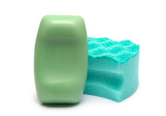 Green soap bar and blue cleaning sponge isolated on white background
