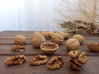 whole and peeled walnuts on a wooden background