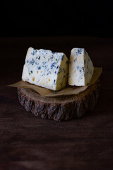 blue cheese on a wooden frame on a wooden background in rustic style