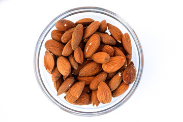 Shelled almonds inside a glass bowl.