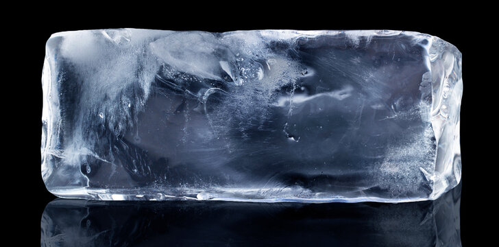 Rectangular block of ice isolated on a black background with clipping path.