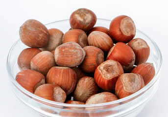 Hazelnuts inside a glass bowl.