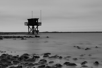 Fototapeta na wymiar Smal watchtower looking out over the Grevelingen Lake in The Netherlands on a grey day