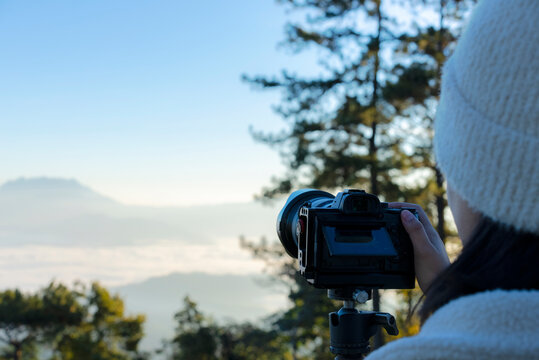 Close-up image of photographer taking a photo on top mountain in the winter, Thailand.
