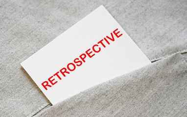 RETROSPECTIVE text on the white sticker in the shirt pocket.