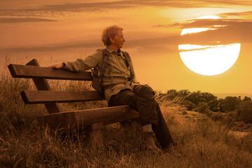 Naklejka na ściany i meble on a bench resting woman at sunset
