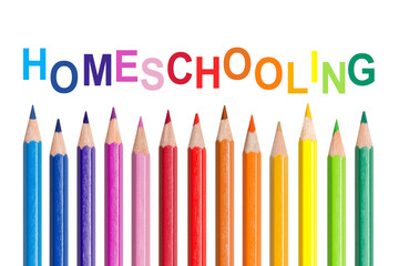 Text homeschooling with many colorful pencils, isolated on white background