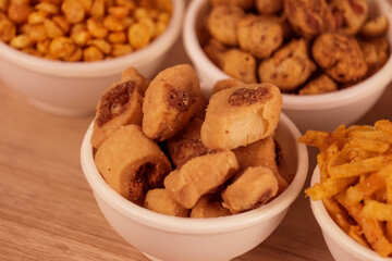 bhakharivadi food,Namkeen, Farsan,Indian spicy snack Namkeen mixture with fried cashew nuts and almonds,savory, Namkeen in a bowl wooden background