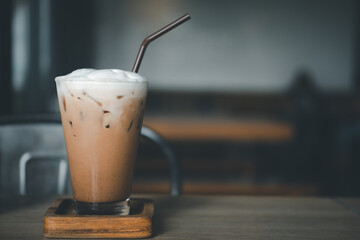 Iced Mocha coffee in a glass decoration with cream on top on a wood table
