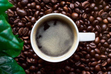 cup of coffee on coffee beans 