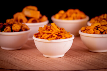 farali chavna in white bowl,Namkeen, Farsan,Indian spicy snack Namkeen mixture with fried cashew nuts and almonds,savory, Namkeen in a bowl wooden background
