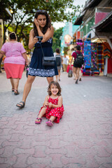 Beautiful woman and a little girl in a colorful alley