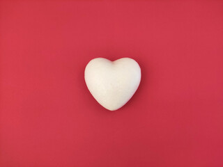 White heart shaped on pink background