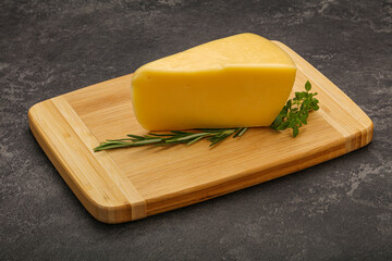 Hard cheese piece served rosemary