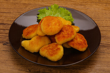 Fried chicken nuggets served salad leaves