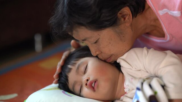 Mother seduces the child to sleep on the bed