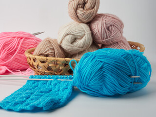 Fototapeta na wymiar Needlework crochet, top view of yarn balls, flat spoon on light wood close-up