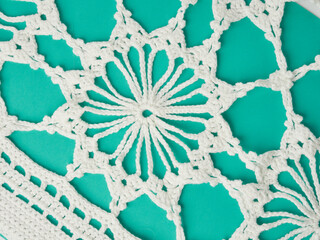 Needlework crochet, top view of yarn balls, flat spoon on light wood close-up