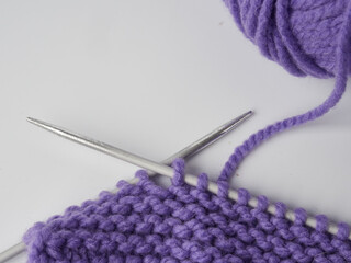 Needlework crochet, top view of yarn balls, flat spoon on light wood close-up