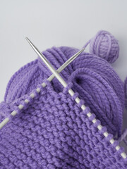 Needlework crochet, top view of yarn balls, flat spoon on light wood close-up