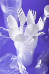 single use plastic cups, forks, spoons. concept of recycling plastic, plastic waste