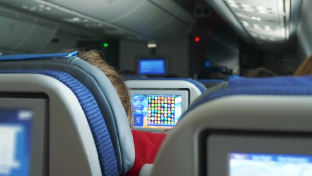 Passenger playing game during flight in 4k slow motion 60fps